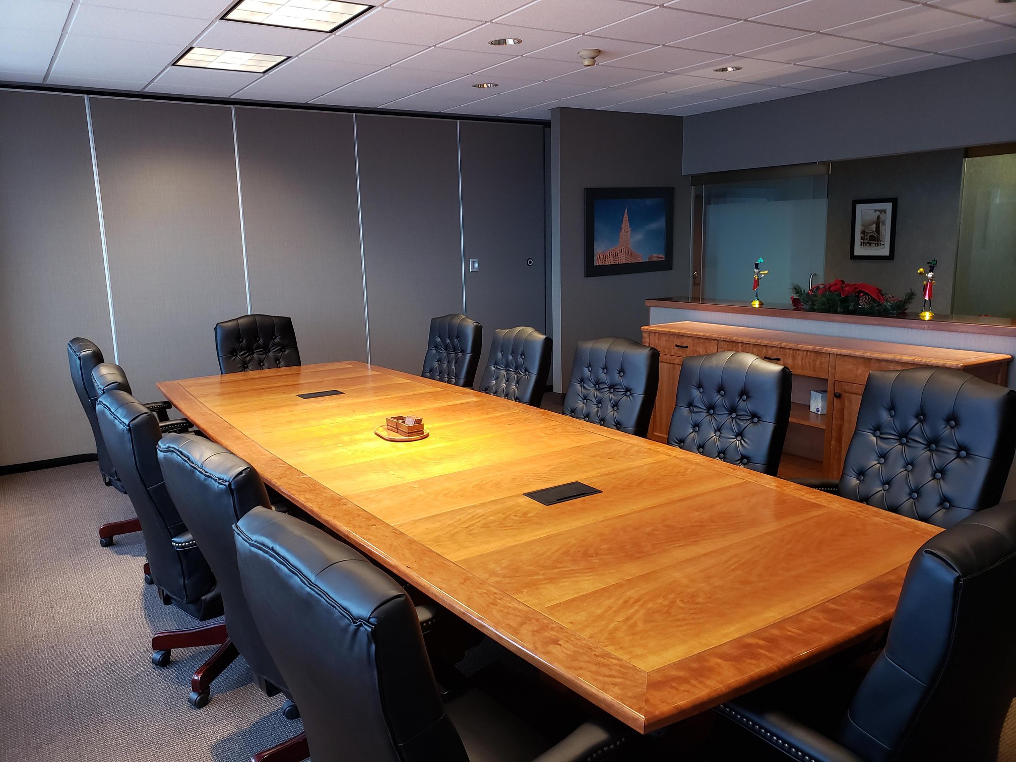 The Main Conference Room at Law Offices of Cleveland, featuring a large table, ergonomic chairs, and video conferencing equipment.